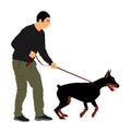 Owner keeps the Doberman pincher champion dog on the leash .