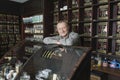 Owner Leaning On Display Cabinet In Shop Royalty Free Stock Photo