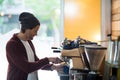 Owner making cup of coffee in espresso machine Royalty Free Stock Photo
