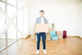 Owner With Moving Box Standing In Newly Purchased House Royalty Free Stock Photo