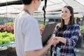 The owner of an organic vegetable farm joins hands with the capitalist to congratulate together the trading of produce