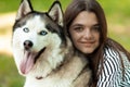 Owner and pet portrait. Teenage girl and her beloved dog. People hugs a husky Royalty Free Stock Photo