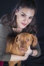 Owner petting a young hungarian vizsla