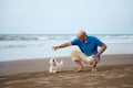 Owner playing with Maltese dog