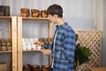 An owner of vase brand checks online and physical inventory and maintains a diary record to determine product availability. A