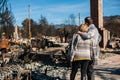 Owners, checking burned and ruined house and yard after fire