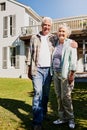 Owning our own home paid off. a happy senior couple standing together in front of their house. Royalty Free Stock Photo