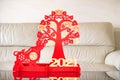 an ox mascot and money tree as symbol of Chinese New Year of the Ox in front of a sofa the Chinese means good luck