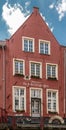 Oxblood red facade along Lieve River in Gent, Flanders, Belgium