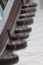 Line of tyres along side a barge for buffer safty Royalty Free Stock Photo