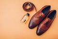 Oxford male brogues shoes with accessories. Men`s fashion. Classical brown leather footwear with belt and perfume Royalty Free Stock Photo