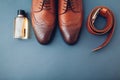 Oxford male brogues shoes with accessories. Men`s fashion. Classical brown leather footwear with belt and perfume Royalty Free Stock Photo