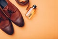Oxford male brogues shoes with accessories. Men`s fashion. Classical brown leather footwear with belt and perfume Royalty Free Stock Photo