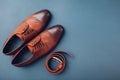 Oxford male brogues shoes with accessories. Men`s fashion. Classical brown leather footwear with belt. Space Royalty Free Stock Photo