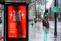 OXFORD STREET, LONDON, ENGLAND- 17th February 2021: Wear a face covering on public transport advertisement on a TFL bus stop Royalty Free Stock Photo