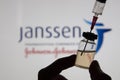 OXFORD, UK - February 2020: A covid vaccine syringe against the Janssen logo