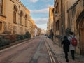 Oxford, United Kingdom: Photograph of couple strolling through the streets of Oxford