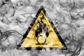 Oxidising materials hazard warning smoke sign. Triangular warning hazard sign, smoke background. Royalty Free Stock Photo