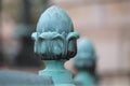 Oxidized acorn in front of brick facade