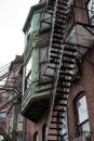 Oxidized copper detail on rear of brownstone rowhouse metal fire escapes