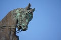 Military statue of horses head against blue sky
