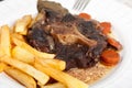 Oxtail stew with carrots and fries