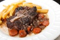 Oxtail stew with carrots and fries