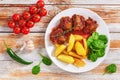 Oxtail stew with fried potato and spinach salad Royalty Free Stock Photo