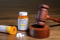 Oxycodone opioid tablets with judge gavel for court decision about liability Royalty Free Stock Photo