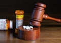 Oxycodone opioid tablets with judge gavel for court decision about liability