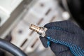 Oxygen sensor for gasoline and diesel engines in the hand against car engine. Mechanic holds oxygen sensor. lambda probe Royalty Free Stock Photo