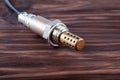 Oxygen sensor for gasoline and diesel engines on wooden table. lambda probe is reliable component to optimize your Royalty Free Stock Photo