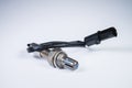 The oxygen sensor is a new lambda sensor. Spare parts on the car on a gray gradient background