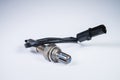 The oxygen sensor is a new lambda sensor. Spare parts on the car on a gray gradient background Royalty Free Stock Photo