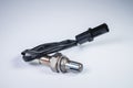 The oxygen sensor is a new lambda sensor. Spare parts on the car on a gray gradient background Royalty Free Stock Photo
