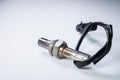 The oxygen sensor is a new lambda sensor. Spare parts on the car on a gray gradient background Royalty Free Stock Photo