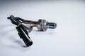 The oxygen sensor is a new lambda sensor. Spare parts on the car on a gray gradient background