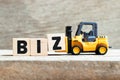 oy forklift hold letter block Z to word biz Abbreviation of business on wood background