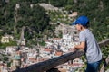 Ãâoy looks into the distance. Rest, walking, children`s, family tourism. Beautiful view of the Amalfi Coast. Italian summer resor