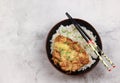 Oyakodon in a bowl boiled rice with chinese chopsticks on a light gray background. Royalty Free Stock Photo