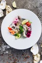 Oysters on a dish decorated with flowers on a gray background. Aphrodisiacs.