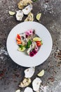 Oysters on a dish decorated with flowers on a gray background. Aphrodisiacs.