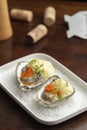 Oysters garnished with red caviar on salt and plate Royalty Free Stock Photo