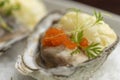 Oysters garnished with red caviar on salt and plate Royalty Free Stock Photo