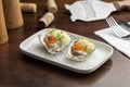 Oysters garnished with red caviar on salt and plate Royalty Free Stock Photo