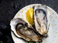 Oysters heart shape in plate, lemon, shells on marble. Delicacy super food, rich in antioxidants, vitamin, zinc