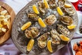 Oysters with lemon and ice on the plate Royalty Free Stock Photo