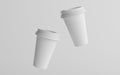 16 oz. Single Wall Paper Large Coffee Cup Mockup with White Lid - Two Floating Cups. 3D Illustration