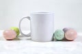 11 oz. White Coffee Mug Mockup with Colorful Speckled Easter Eggs Royalty Free Stock Photo