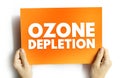 OZONE DEPLETION text on card held by hands, concept of environmental damage and global climate issue Royalty Free Stock Photo